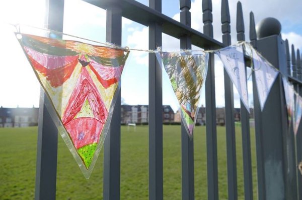 Homemade bunting attached to a park railing