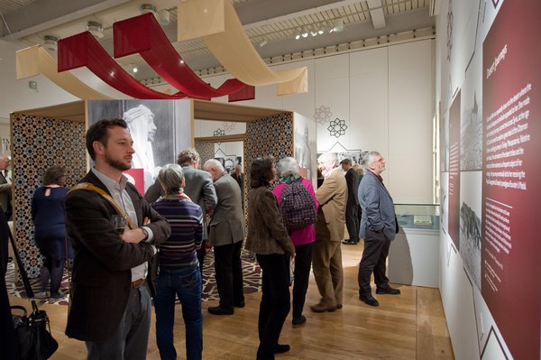 Visitors looking at interpretation panels of the Gertrude Bell exhibition at the Great North Museum